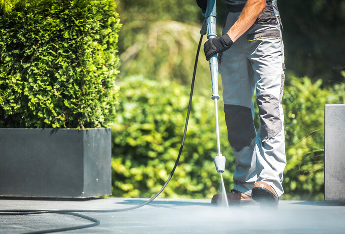 Man Pressure Washing Patio